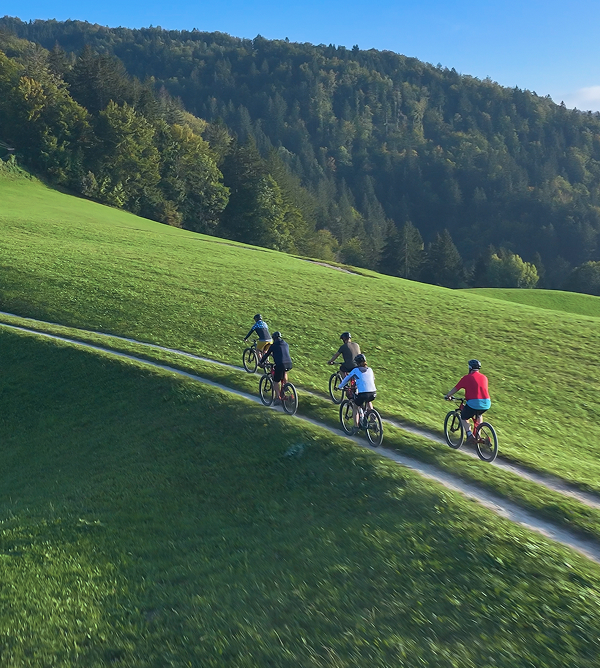 People riding bike on a hill