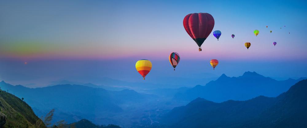 Hot air balloons flying over a destination